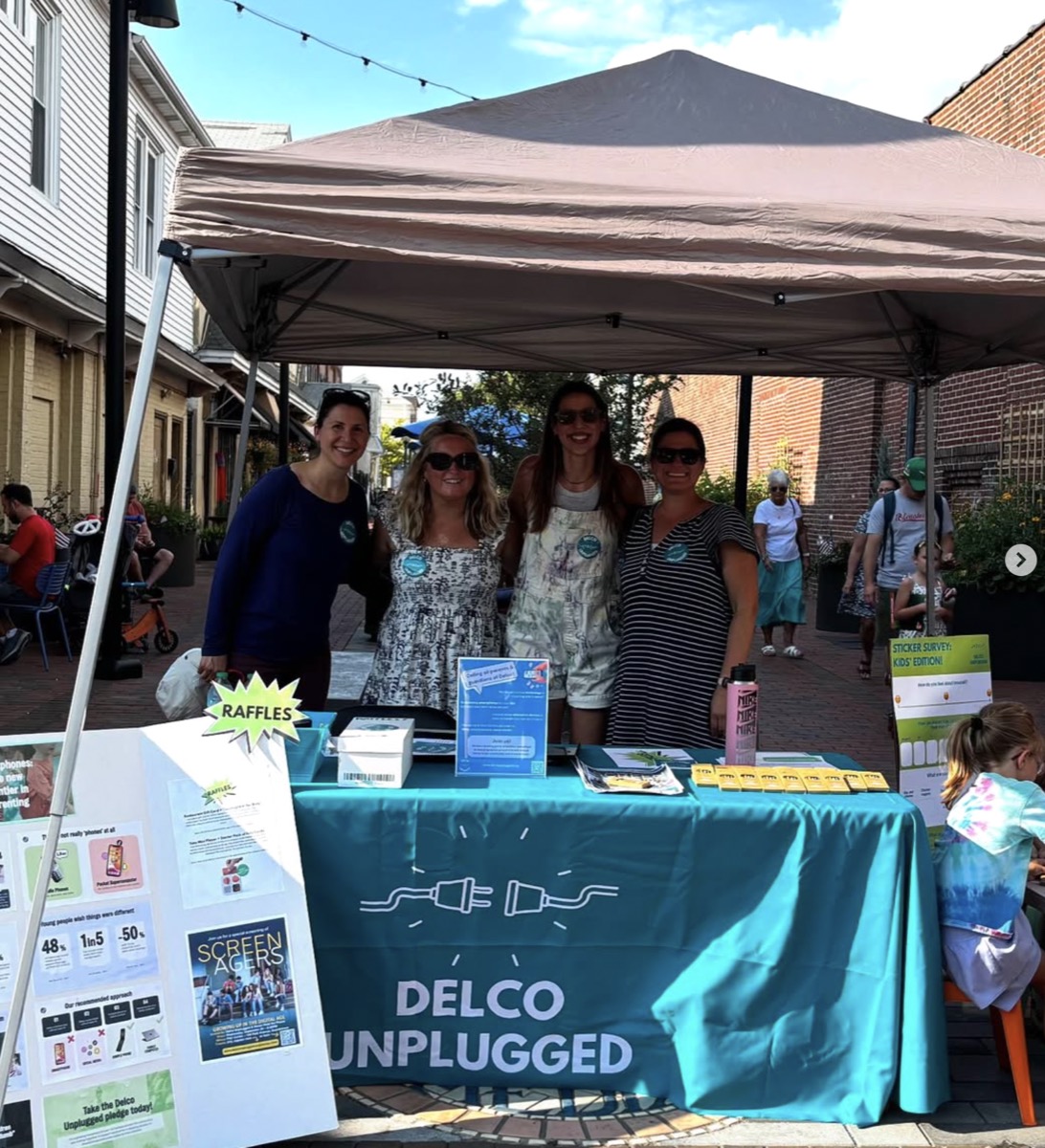 Delco Unplugged families at their table at a local street fair